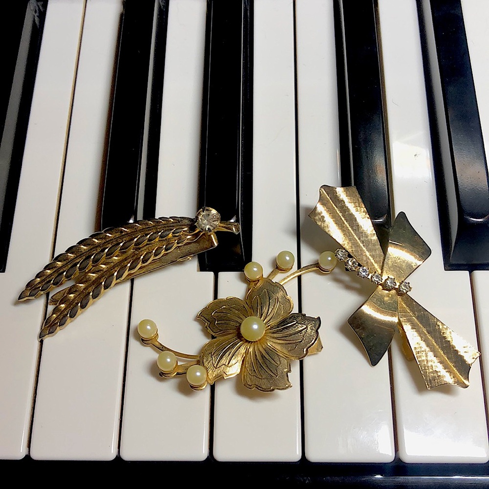 Three vintage gold tone and rhinestone hair clips